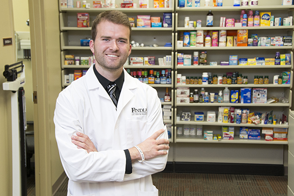 Pharmacy student posing in a pharmacy